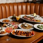 Pasta, steak and cocktails on a table at Americano in Bayonne, NJ