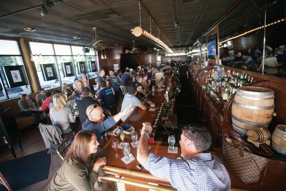 Diners at the bar inside The Brass Rail on Washington Street in Hoboken, NJ