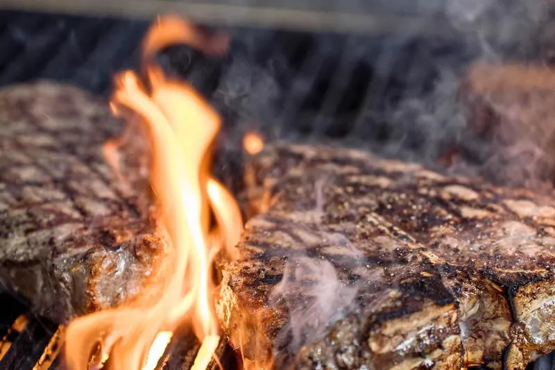 Steaks on the grill at Eleazar Steakhouse in Harrison, NJ
