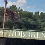 Welcome to Hoboken sign on a railroad bridge in Hoboken, NJ
