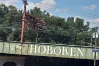 Welcome to Hoboken sign on a railroad bridge in Hoboken, NJ