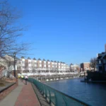 Waterfront walkway along the canal at Port Liberte in Jersey City, near Hudson House, on a sunny day