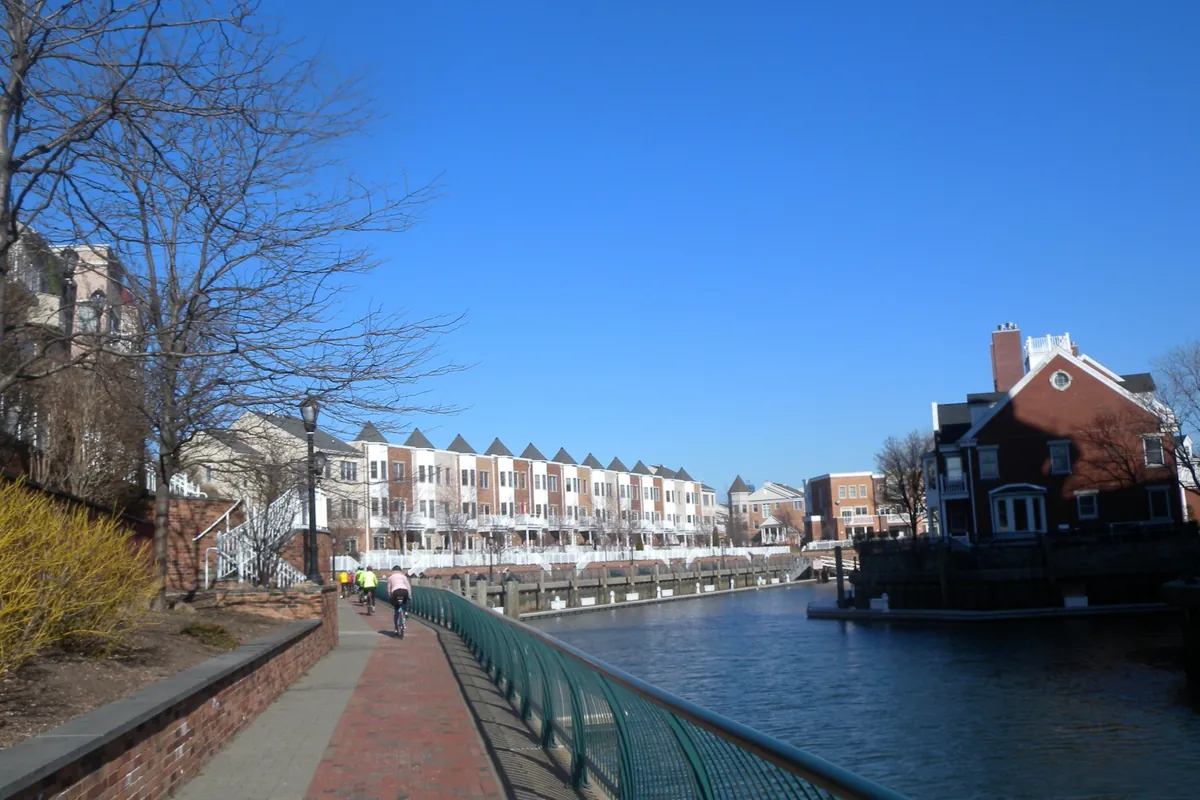 Waterfront walkway along the canal at Port Liberte in Jersey City, near Hudson House, on a sunny day