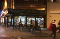 Newark Avenue storefronts on a December evening in Downtown Jersey City, NJ, near the pedestrian mall