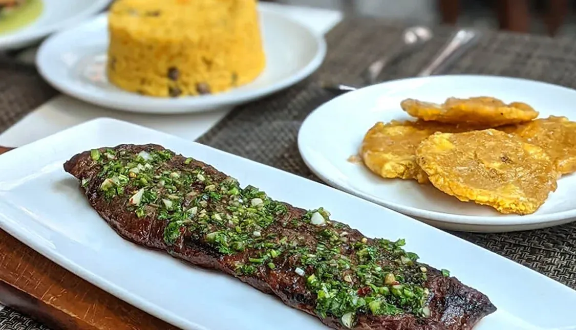 Steak with chimichurri, tostones and rice at La Isla Cuban restaurant in Hoboken, NJ