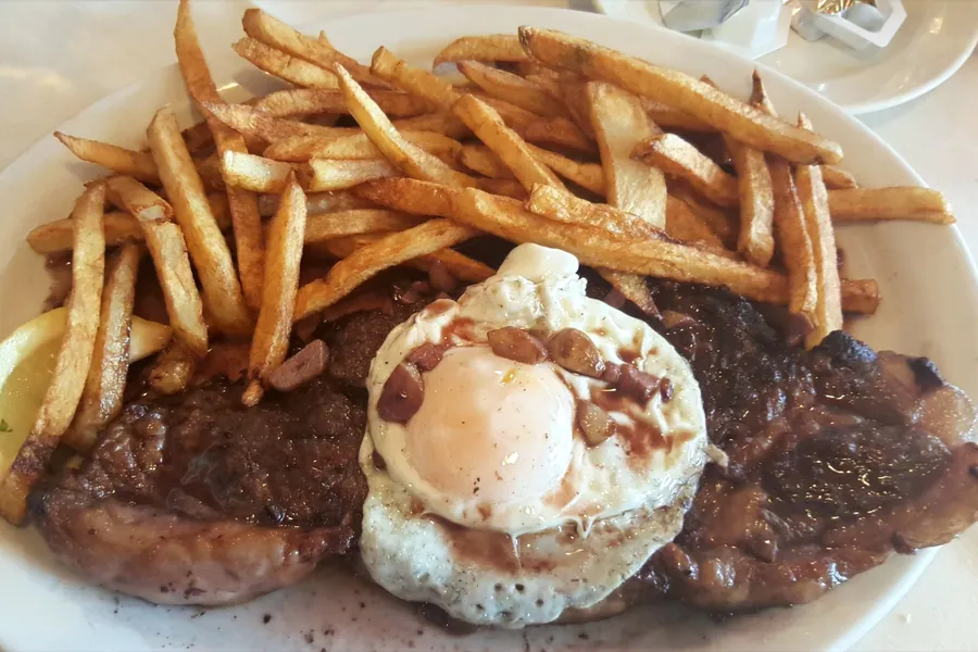 Steak with fried egg and fries at Pic-Nic Restaurant in East Newark, NJ