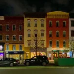 Colorful Washington Street rowhouses and shops in Hoboken on a late November evening